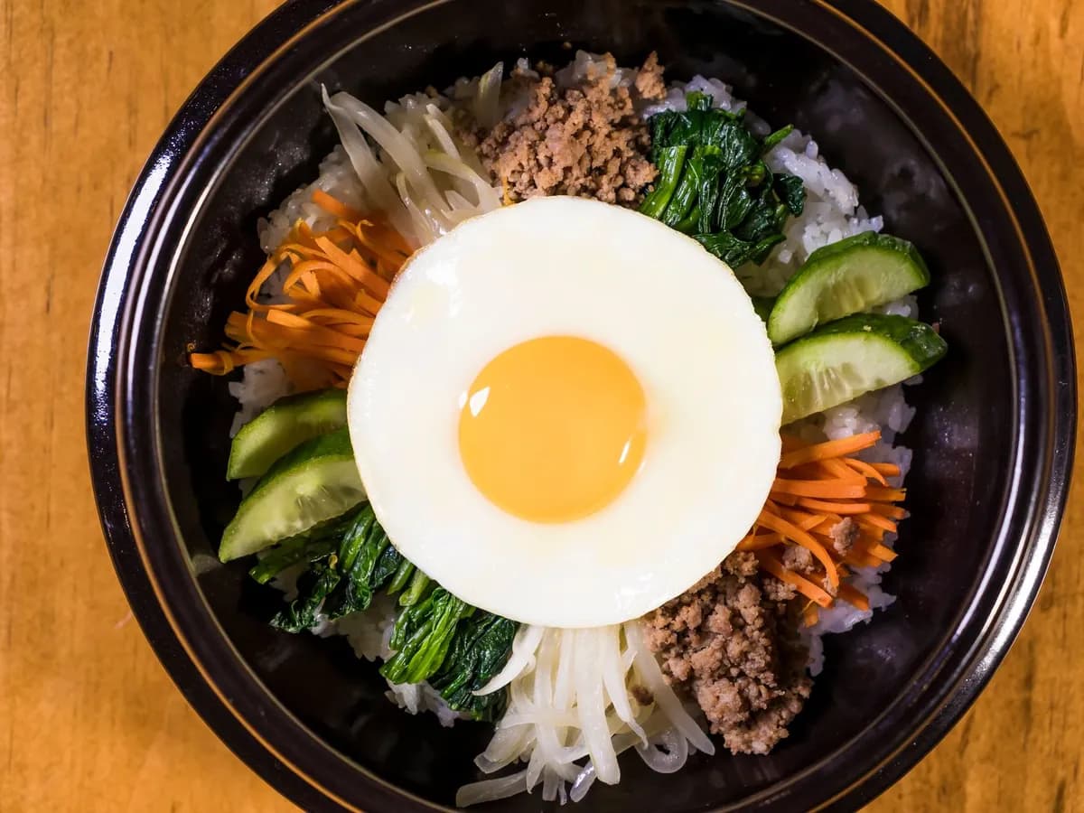 Bibimbap in a stone bowl topped with a fried egg